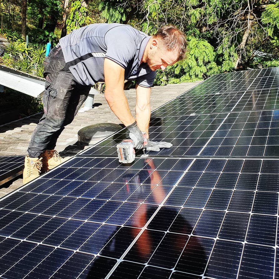 MRF Electrical technician finishing a rooftop solar panel installation