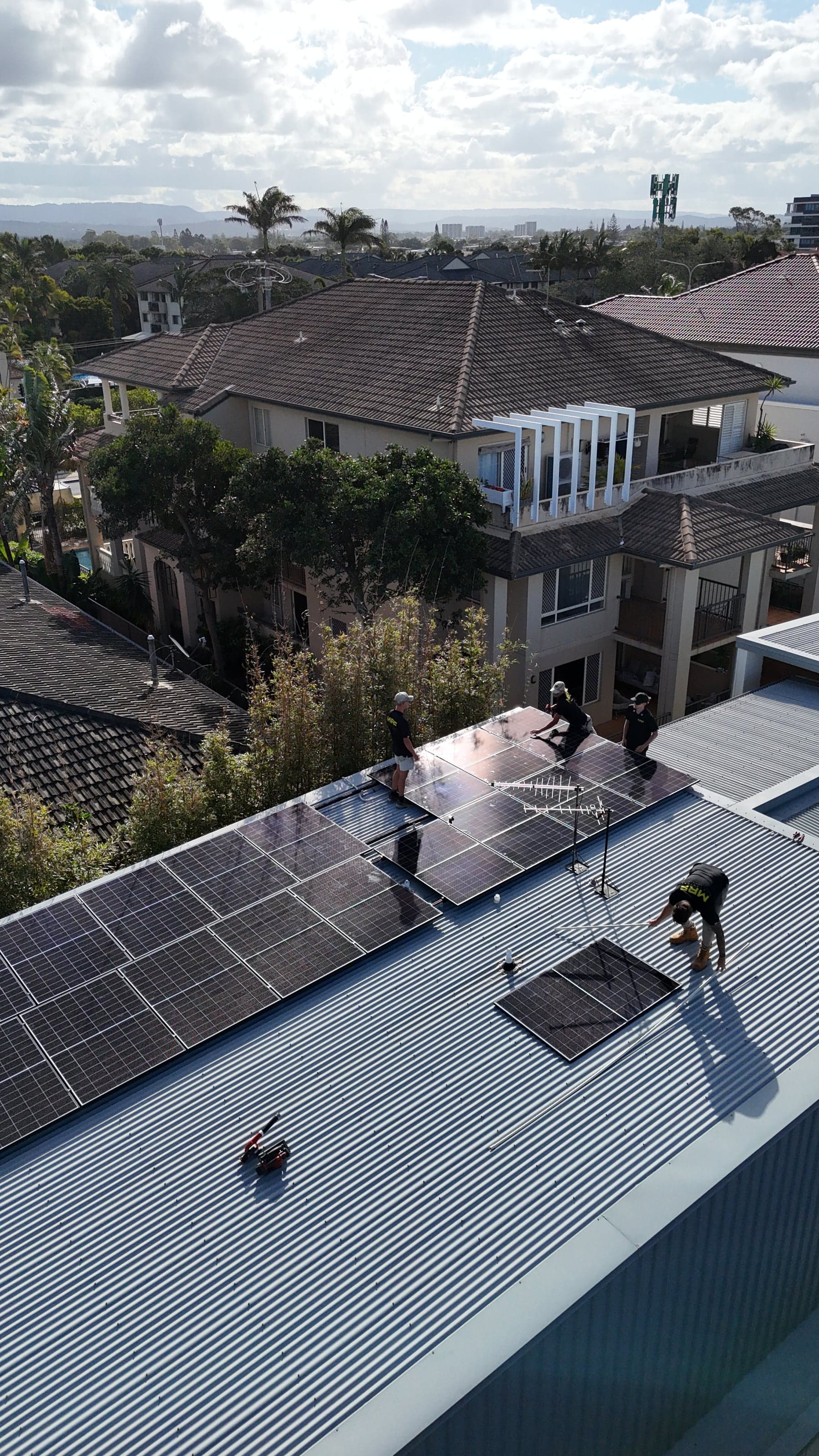 Aerial view of the MRF Electrical team installing a rooftop solar array at Mermaid Beach